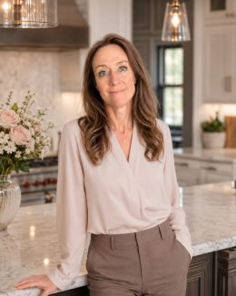 Nicki McCoy leaning on a kitchen island, relaxed and approachable